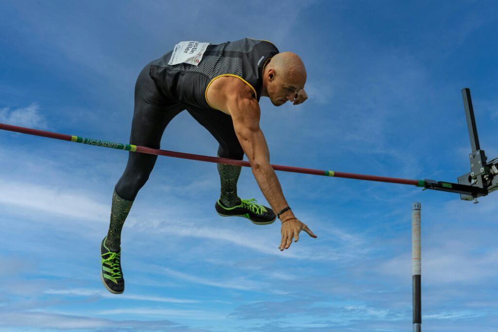 Athlete in action during a pole vault event, showcasing strength and agility.
